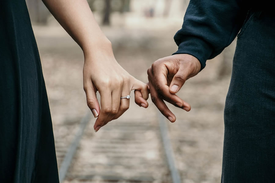 Man and woman with fingers linked