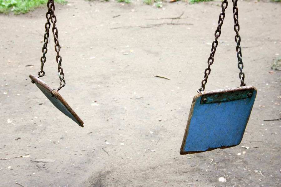 A child's swing broken into two pieces