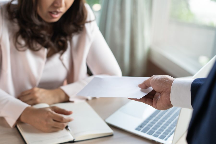 A woman looking aghast at some papers