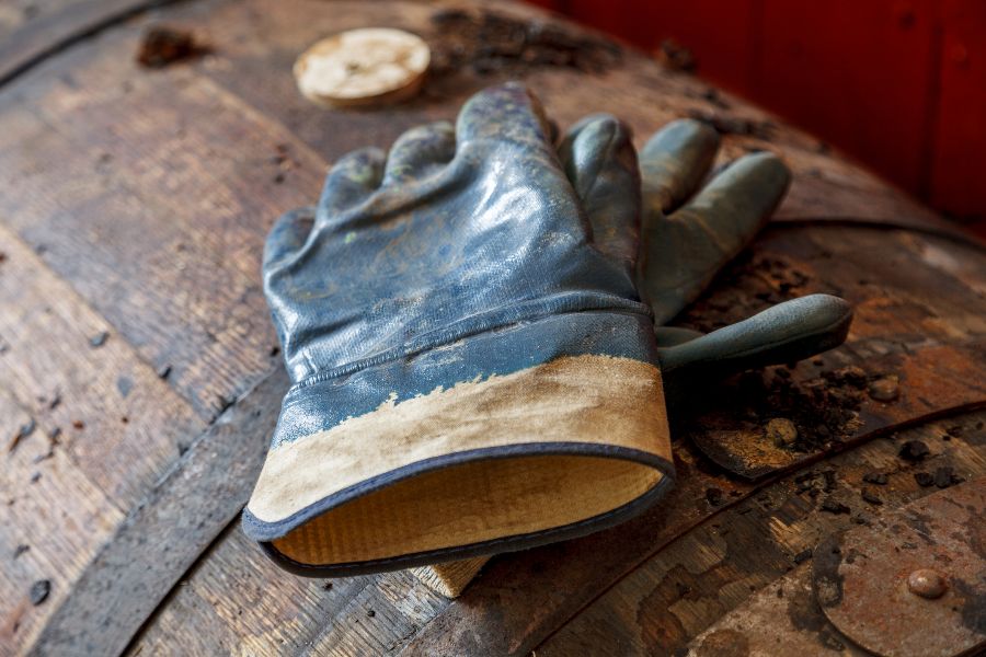 Gloves on a dusty whisky barrel