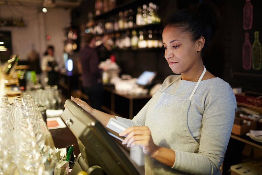 A woman working behind a bar