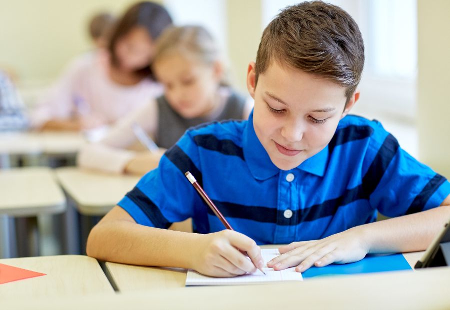 Children writing at school desks