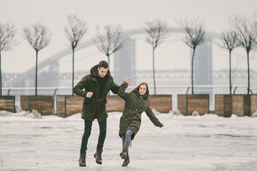 A couple slipping on winter ice