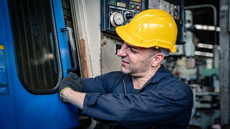 A worker with his arm stuck in machinery